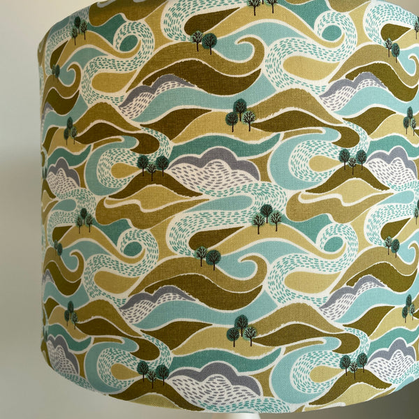 Medium drum style lampshade with hills and trees fabric close up, by shades at grays nz