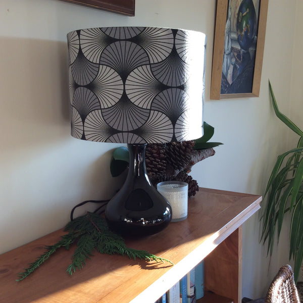 Medium handcrafted fabric lampshade, on black base, by shades at grays