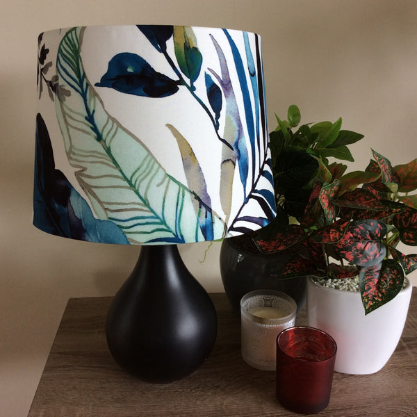 Medium tapered handcrafted fabric lamp shade with watermark palm fabric, unlit.