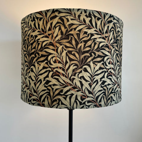 Medium size drum style lampshade with William Morris Willow Boughs black fabric, lit, by shades at grays, nz.