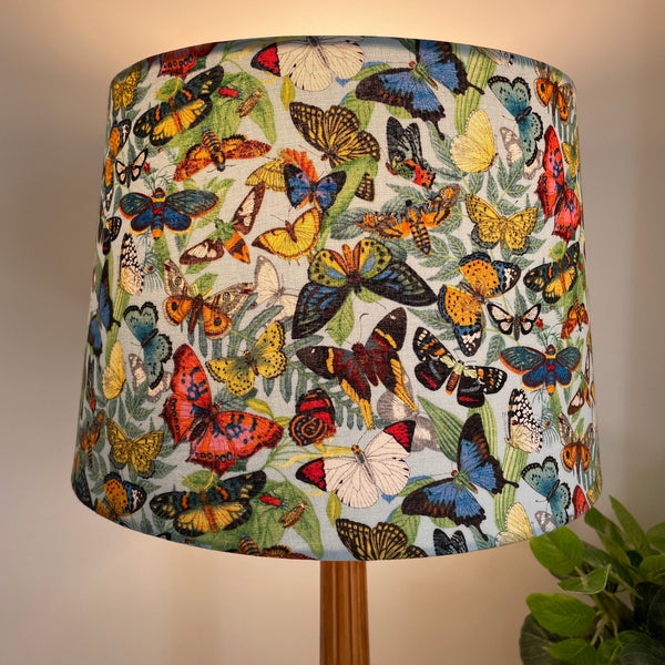 Medium tapered handcrafted fabric lampshade, lit