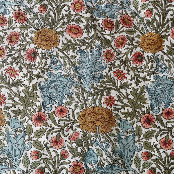 Patterned fabric with floral and leaf designs in blue, red, and green on a white background