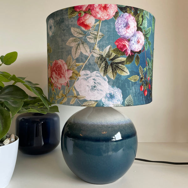 Blue ceramic lamp, unlit with ocean blue floral bespoke fabric lamp shade, made in nz by shades at grays