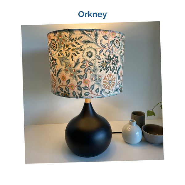 Orkney fabric on medium drum lampshade and black touch base, lit, crafted by shades at grays