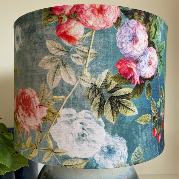 Ocean blue floral bespoke fabric lamp shade, on blue and white ceramic base, unlit.