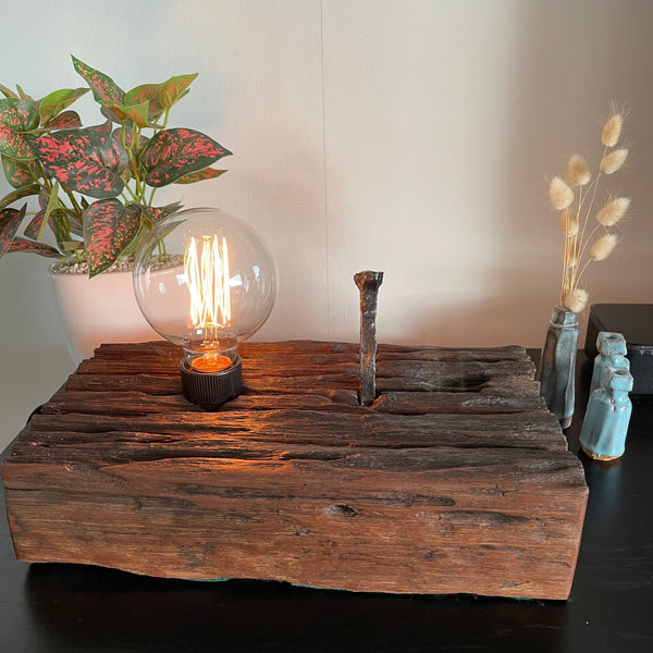 Hand crafted wood lamp created from old railway sleeper with replica edison bulb, lit, made by shades at grays.