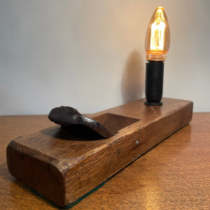 Rare table lamp upcycled from Japanese carpenter's plane with E14 candle bulb, lit by shades at grays.
