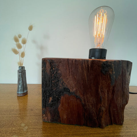 Reclaimed century old wharf timber table lamp created by Shades at Grays, front view with edison bulb lit. 