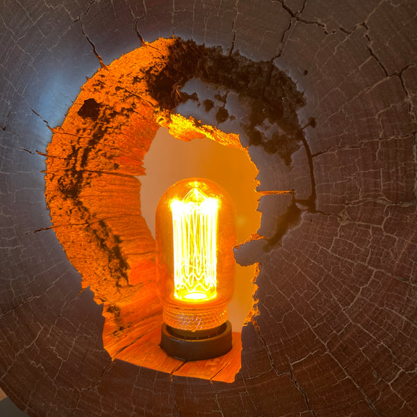 Reclaimed heritage lamp handcrafted from eroded jarrah telegraph pole, lit, close up of left side interior.