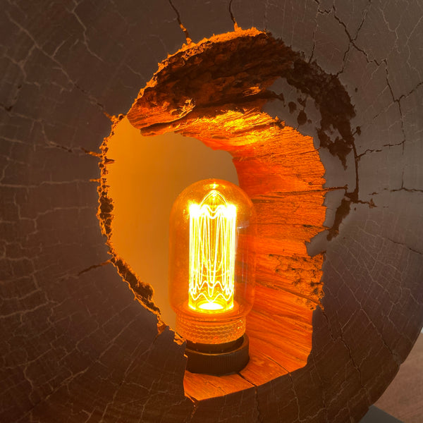 Reclaimed heritage lamp handcrafted from eroded jarrah telegraph pole, lit, close up of right side interior.