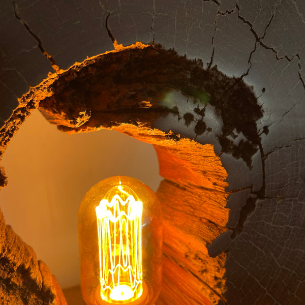 Reclaimed heritage lamp handcrafted from eroded jarrah telegraph pole, lit, close up of top interior.