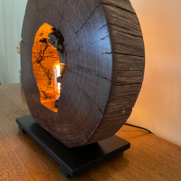 Reclaimed heritage lamp handcrafted from eroded jarrah telegraph pole, lit, right hand side view.