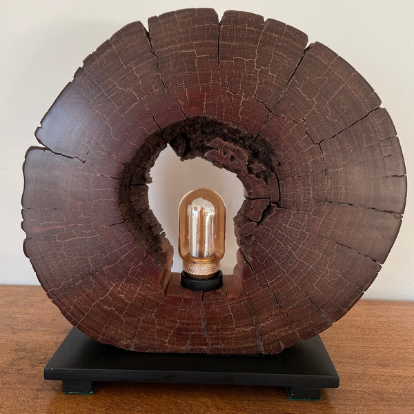 Reclaimed heritage lamp handcrafted from eroded jarrah telegraph pole, unlit, front view.