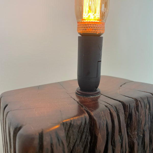 Reclaimed jarrah wharf timber wood table lamp, by shades at grays, close up of natural bees wax polished top surface.