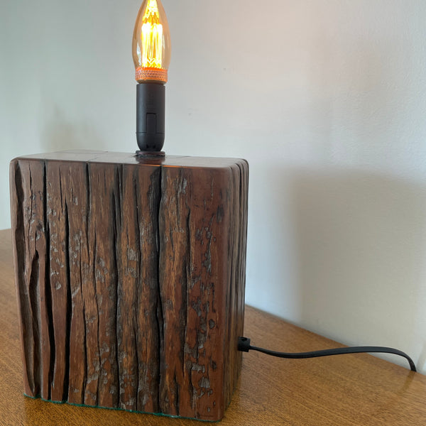 Reclaimed jarrah wharf timber wood table lamp, by shades at grays, side view.