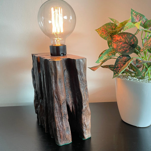 Wood table lamp from reclaimed railway sleeper, with natural erosion and replica edison lamp crafted by shades at grays, side view.