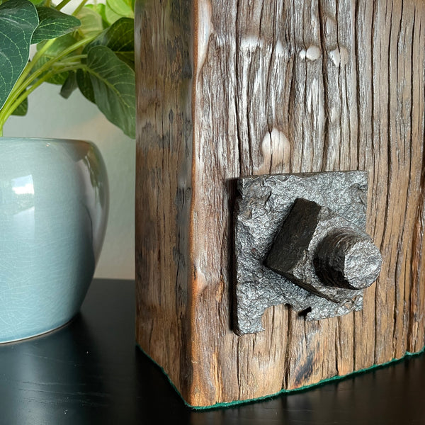 Unique wood lamp created from reclaimed wharf timber, close up of original bolt and wood grain.