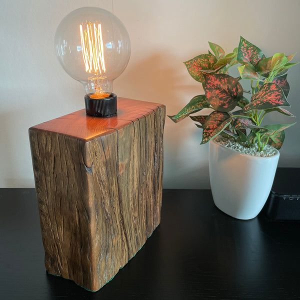 Unique timber wood lamp created from reclaimed wharf timber, lit, side and front view.