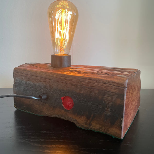 Reclaimed wharf timber table lamp, handcrafted by shades at grays with replica edison bulb, back view.