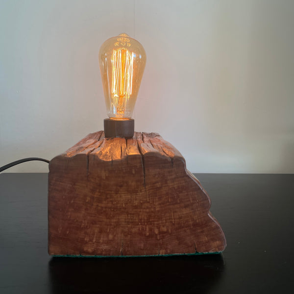 Reclaimed wharf timber table lamp, handcrafted by shades at grays with replica edison bulb, side view.