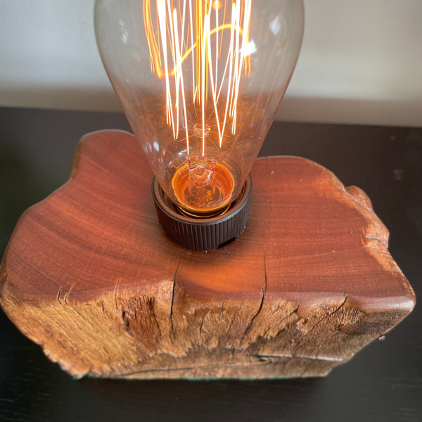 Reclaimed wood table lamp, warm red polished top with edison bulb, lit, created by Shades at Grays