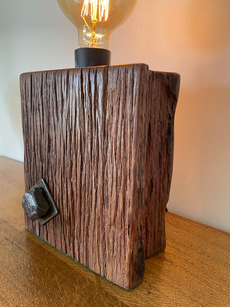 Reclaimed wood table lamp crafted by shades at grays with original bolt and eroded grooves.