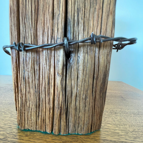 Reclaimed wood table lamp handcrafted by shades at grays from authentic totara fence post, close up of original wire, barbs have been blunted.