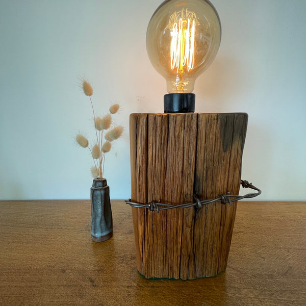 Reclaimed wood table lamp handcrafted by shades at grays from authentic totara fence post with original wire.