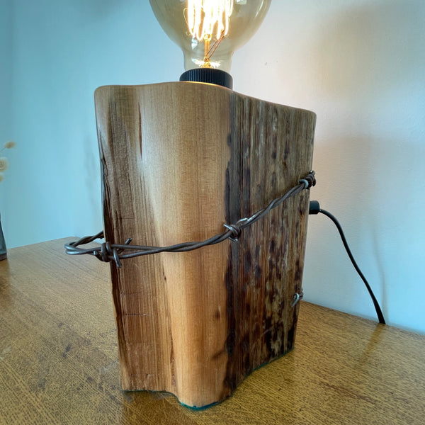 Reclaimed wood table lamp handcrafted by shades at grays from authentic totara fence post with original wire, back and side view.