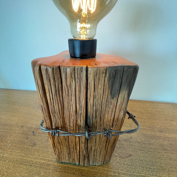 Reclaimed wood table lamp handcrafted by shades at grays from authentic totara fence post with original wire, top and front view.