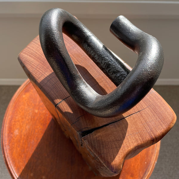 Restored wharf timber and authentic railway iron crafted by shades at grays into door stop, close up of top view and railway iron.