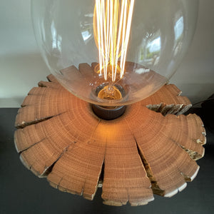 Round telegraph jarrah post upcycled into wood table lamp with addition of edison bulb, lit, close up of polished top, crafted by shades at grays.