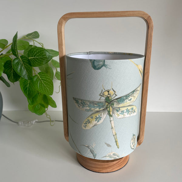 Scandi style table lamp with blue dragonfly fabric, unlit, by shades at grays.