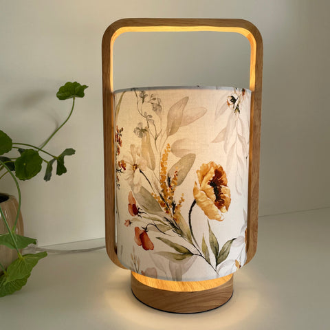 Scandi style table lamp with floral print, crafted by shades at grays, nz, lit.