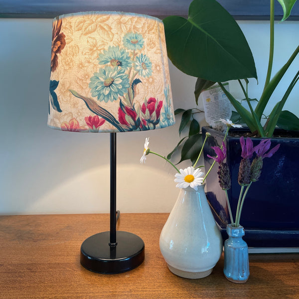 Shade at grays small tapered handcrafted fabric lamp shade, on small black base.