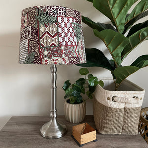 Shades at grays medium tapered handcrafted fabric lampshade, unlit, on brushed chrome base.