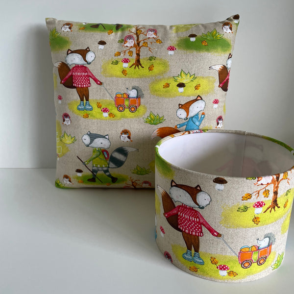 Small drum lampshade in fox fabric with matching cushion.