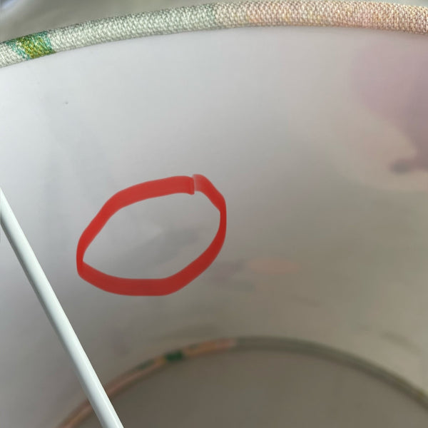 Small area of damage to interior plastic, pointed out by red circle.