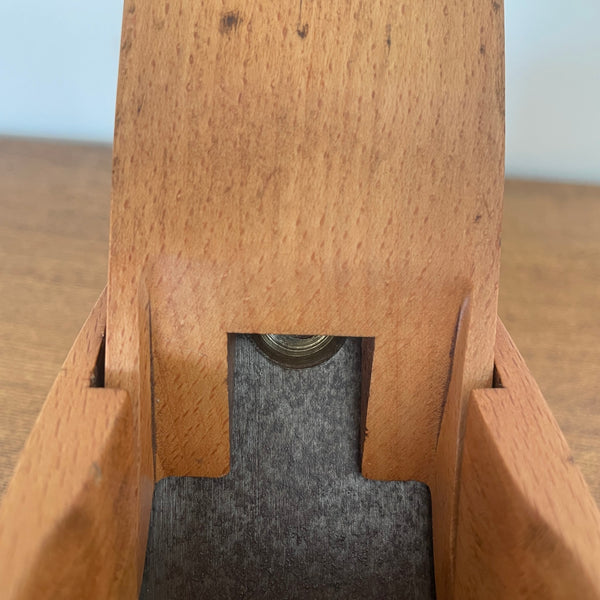 Small carpenters plane upcycled by shades at grays close up of mid section.