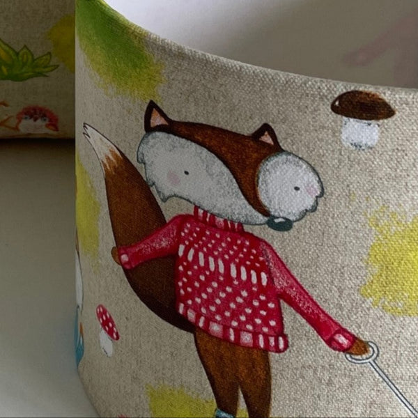 Small drum lampshade in fox fabric close up.
