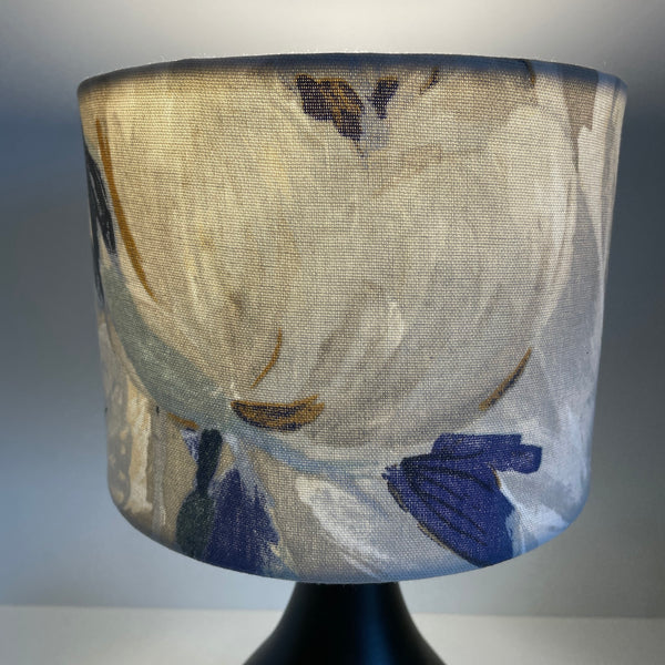 Small drum lampshade with two tone roses blue fabric, lit, large white bud.