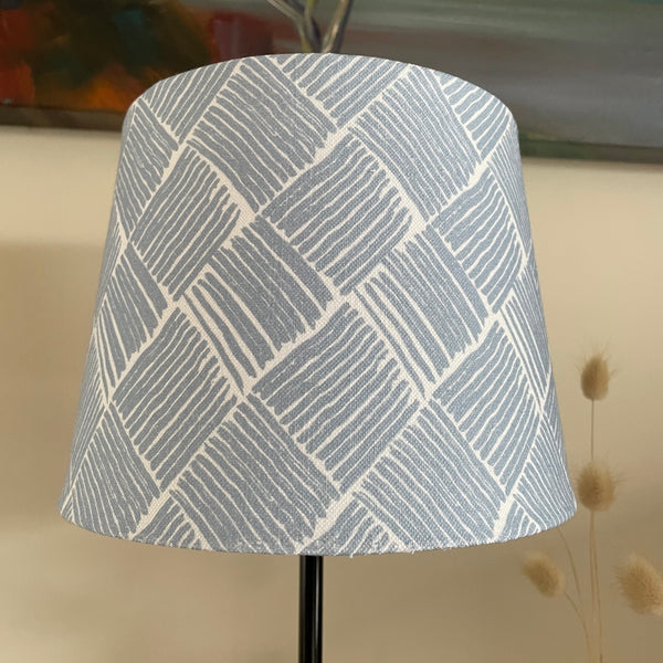 Small tapered handcrafted fabric lamp shade, unlit.