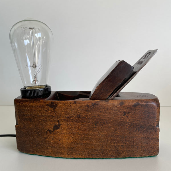 Wooden table lamp, handcrafted from vintage carpenter's plane, dark honey wood and edison bulb, unlit.