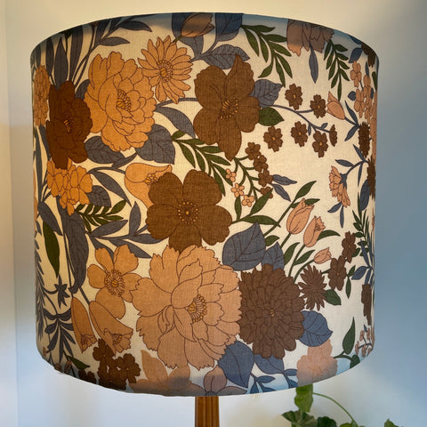 Mid century floral print on large drum lamp shade, hand made by shades at grays, made in nz, lit.
