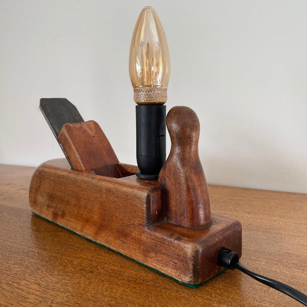 Table lamp handcrafted by shades at grays from authentic carpenter's plane, with LED candle E14 bulb, unlit, back and side view.