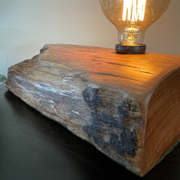 Table lamp crafted from reclaimed wharf timber, with replica edison bulb by shades at grays, nz, with replica edison bulb and close up of original markings..