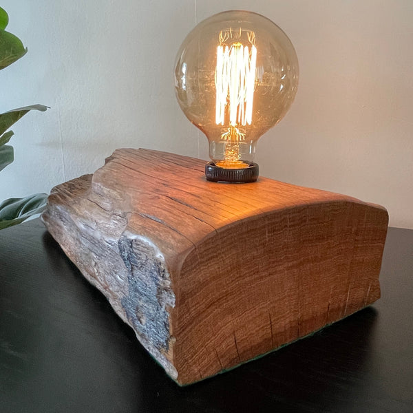 Table lamp crafted from reclaimed wharf timber, with replica edison bulb by shades at grays, nz, smooth finish to end..