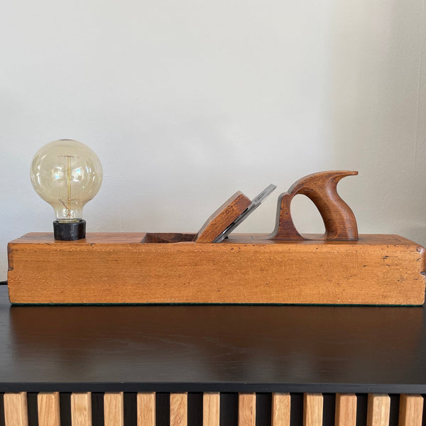 Table lamp made from authentic wood plane by shades at grays, nz, warm golden wood, unlit.