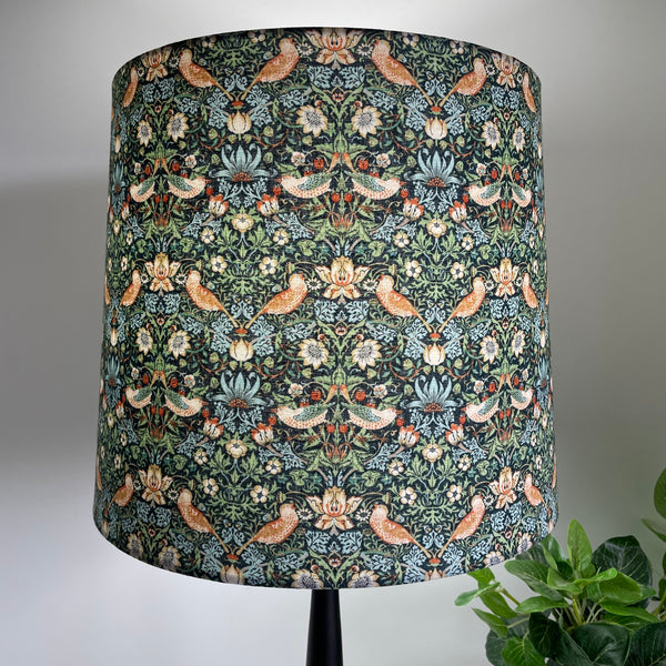 Tapered 30 lampshade with strawberry thief mini marine fabric, lit, crafted by shades at grays.