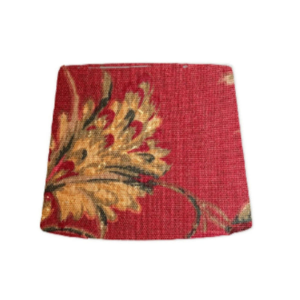 Tapered style lamp shade with golden harvest on red fabric.